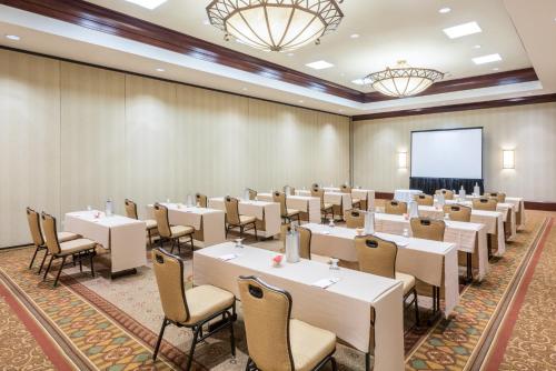 a room with tables and chairs and a projection screen at Crowne Plaza Providence-Warwick (Airport) by IHG in Warwick