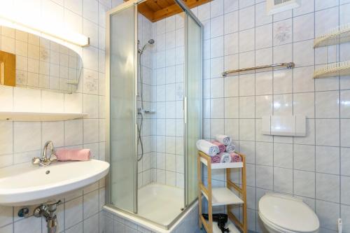 a bathroom with a shower and a toilet and a sink at Biobauernhof Stegerbauer in Maria Alm am Steinernen Meer