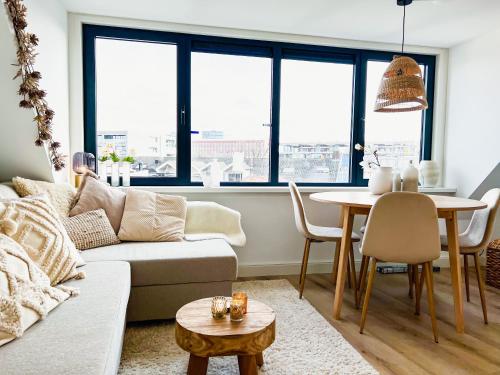 un soggiorno con divano e tavolo di Catharine Suite a Breda