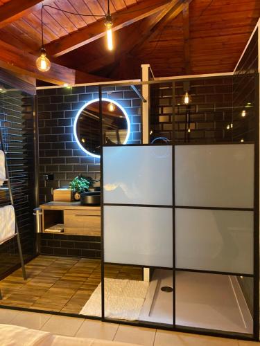 a room with a glass partition in front of a brick wall at Sky Luxury Suite in Keszthely