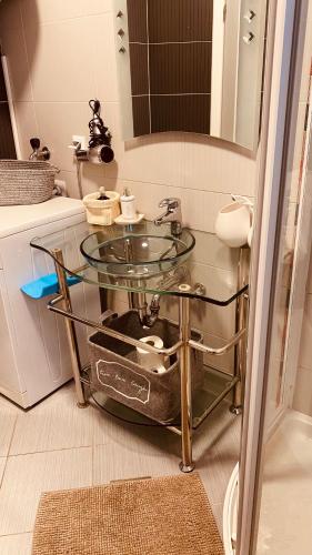 a bathroom with a glass sink and a mirror at Vila Bianca in Umag
