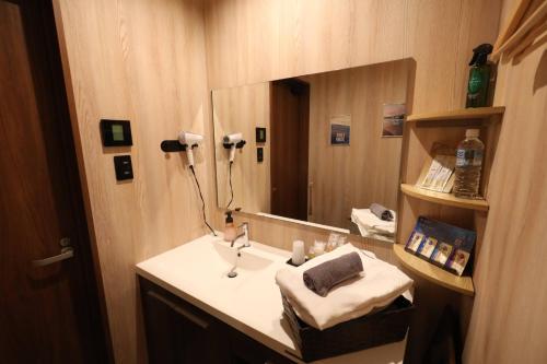 a bathroom with a sink and a mirror at Takahashi Building 3rd and 4th floors - Vacation STAY 25198v in Musashino