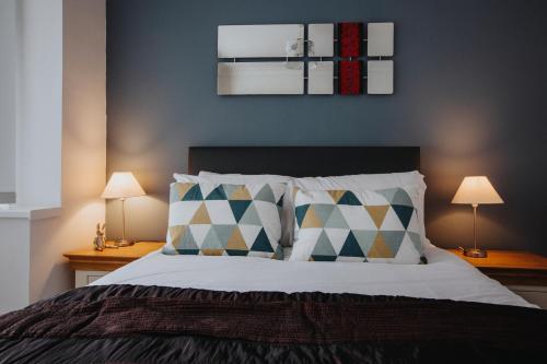 a bedroom with a large bed with two lamps on tables at Hillside House - 2 Bedrooms parking WI-FI Hospital in Blackpool