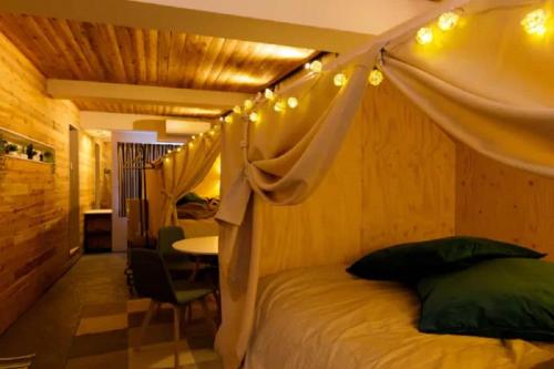 a bedroom with a bed with a canopy and lights at Ōgi-en building 3 - Vacation STAY 12594 in Tokyo