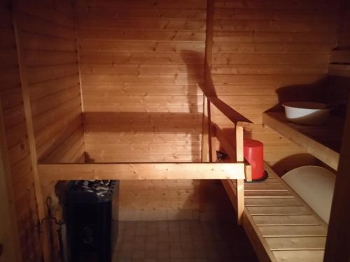 an inside view of a wooden sauna with a tub at Riverside Restplace in Tornio