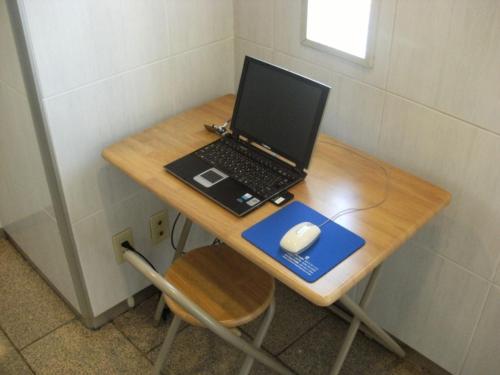 a laptop computer sitting on a table with a mouse at Central Hotel Toride - Vacation STAY 09921v in Toride