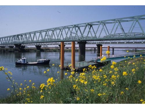 a bridge over a river with boats in the water at Central Hotel Toride - Vacation STAY 09920v in Toride