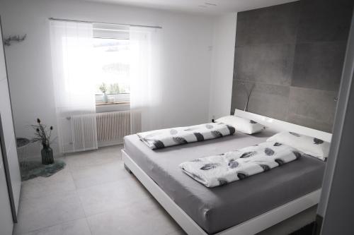 a bedroom with two beds and a window at Ferienwohnung Panoramablick-Rhön in Sandberg