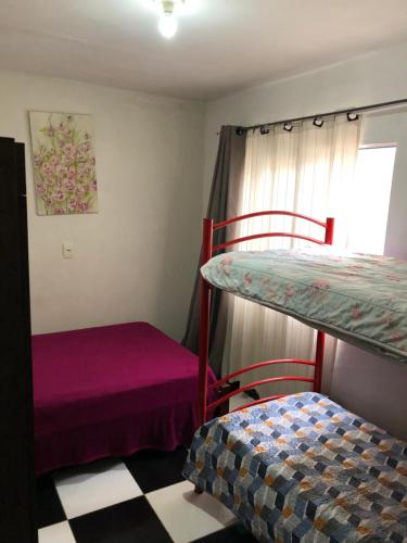 a bedroom with two bunk beds and a window at Casa na melhor localidade de BC in Balneário Camboriú