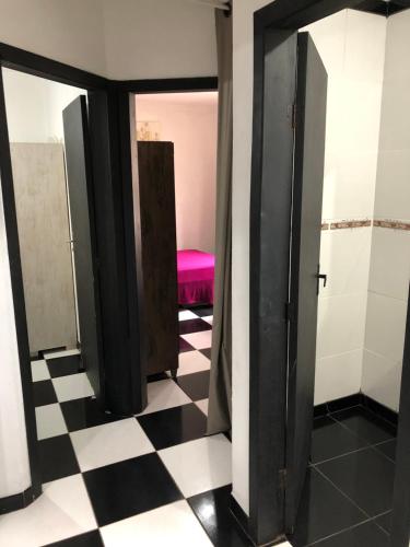 a room with doors and a checkered floor at Casa na melhor localidade de BC in Balneário Camboriú