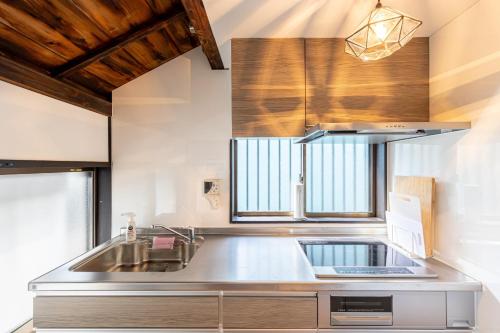 a kitchen with a stainless steel sink and a window at Bettei Enoshima - Vacation STAY 20399v in Kamakura