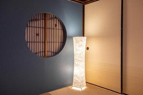 a light next to a door with a mirror at Bettei Enoshima - Vacation STAY 20399v in Kamakura