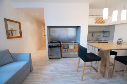 cocina y sala de estar con sofá y mesa en Appartamento Trentino, en Molina di Ledro
