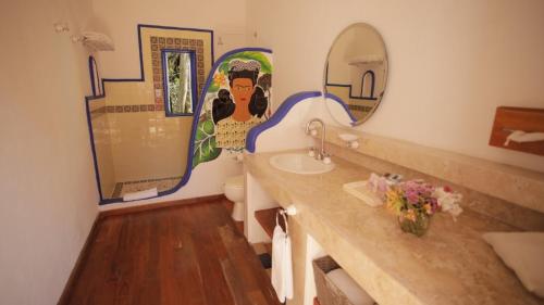 a bathroom with a sink and a mirror at Hotel La Casa de los Árboles Immersive Experience in Zacualpan de Amilpas