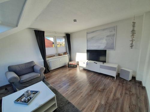 a living room with a couch and a flat screen tv at Möwe 7 in Grömitz