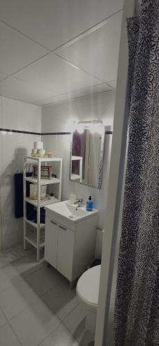 a white bathroom with a toilet and a sink at Aguazul 120 in Tías