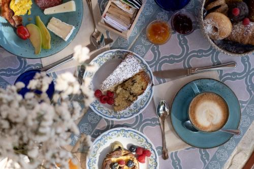 a table topped with plates of food and a cup of coffee at Hotel Punto Verde in Marina di Campo