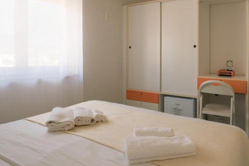 a room with a bed with towels on it at Hotel Punto Verde in Marina di Campo