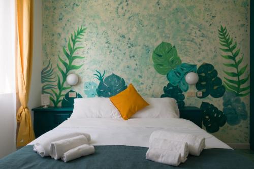 a bedroom with a bed with towels on it at Hotel Punto Verde in Marina di Campo