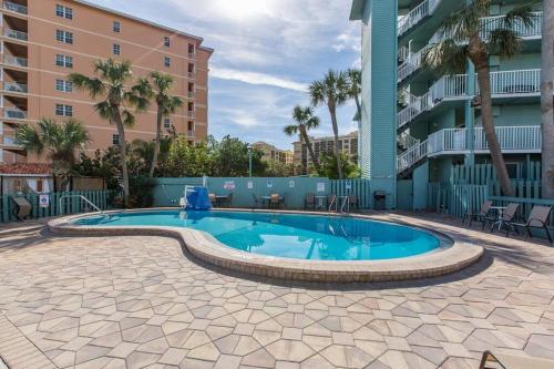 a swimming pool in the courtyard of a apartment building at Beach Haven in South Clearwater Beach in Clearwater Beach