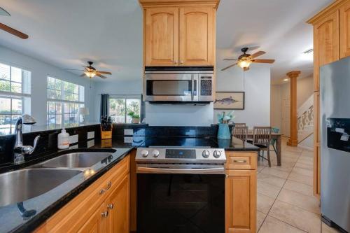a kitchen with a sink and a stove top oven at Beach Haven in South Clearwater Beach in Clearwater Beach