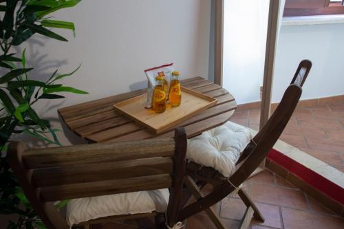 a wooden table with two bottles of beer on it at Affittacamere Carnevali MJ in Loreto