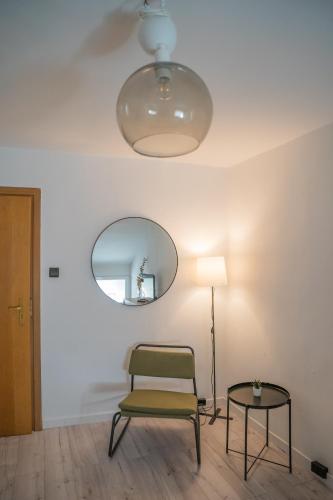 a chair and a table in a room with a mirror at Moon Hostel Warszawa in Warsaw