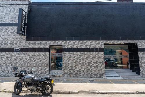 a motorcycle parked in front of a brick building at Ayenda Malaki in Medellín
