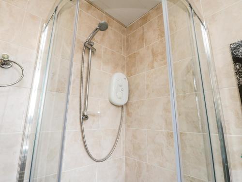 a shower with a shower head in a bathroom at Yeoman Terrace in Marske-by-the-Sea