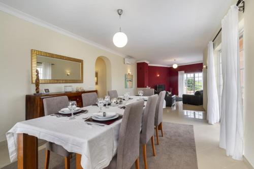 a dining room with a long table and chairs at Villa Arade Riverside - Jacuzzi and Heated Pool by AlgarStays in Silves