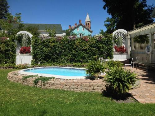 a swimming pool in the yard of a house at The White House Inn in Cooperstown