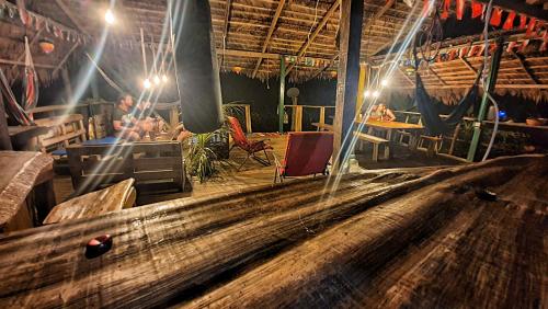 a man is sitting in a large room with a table at Hakuna Matata Ecolodge in El Valle