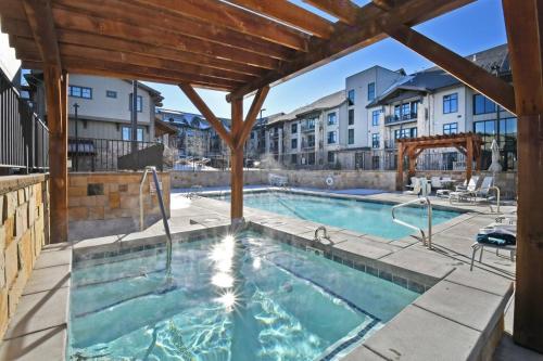 a swimming pool with a building in the background at Blackstone Beauty condo in Park City