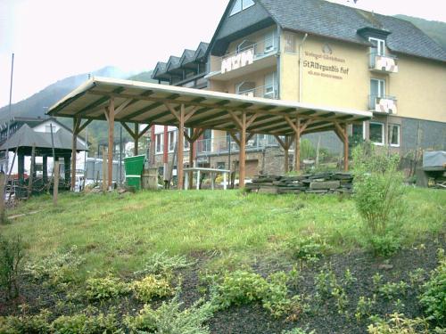 a building with a pavilion in front of a field at Wein- und Gästehaus St. Aldegundishof in Sankt Aldegund