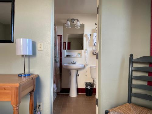 a bathroom with a sink and a toilet in it at Rugged Country Lodge in Pendleton