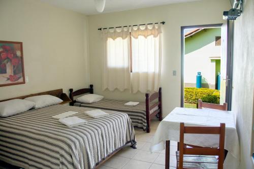 Een bed of bedden in een kamer bij Hotel Fazenda Monte Sião
