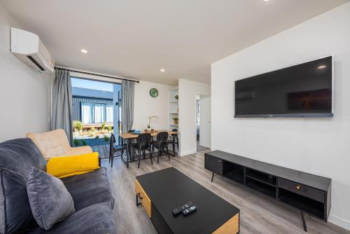 a living room with a couch and a flat screen tv at Tekapo Top 1000 Apartment in Lake Tekapo