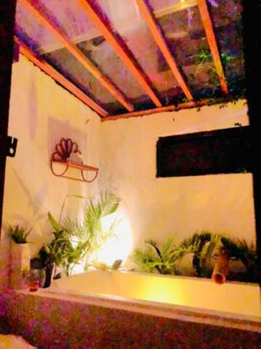 a room with a bath tub with plants in it at Rancho Oco Mahogany Loft Type Villa in Nasugbu