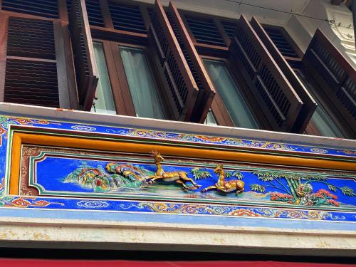 a building with a painting on the side of it at Nam Keng Hotel Penang in George Town