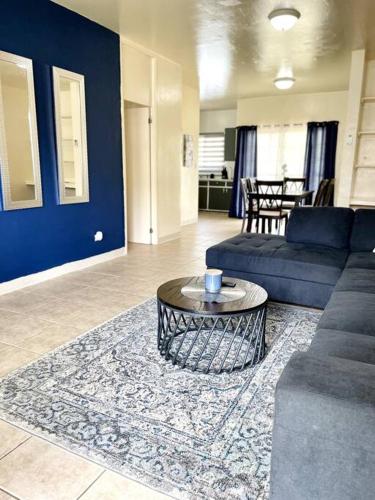 a living room with a couch and a coffee table at beautiful 4 bedroom tumon house in Tamuning