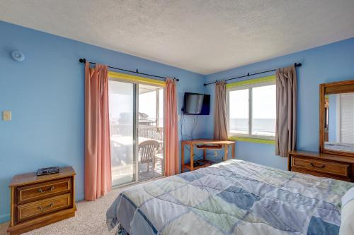 a bedroom with a bed and a view of the ocean at Skip 713 RR in Rodanthe