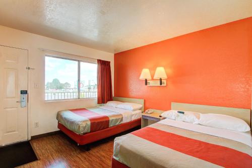 a hotel room with two beds and a window at Motel 6-Denver, CO - Airport in Denver