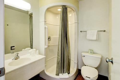 a bathroom with a toilet and a sink and a shower at Motel 6-Denver, CO - Airport in Denver