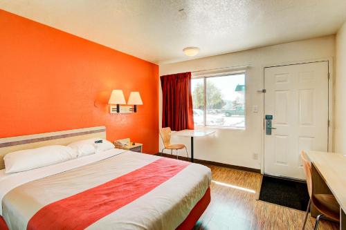 a hotel room with a bed and a window at Motel 6-Denver, CO - Airport in Denver
