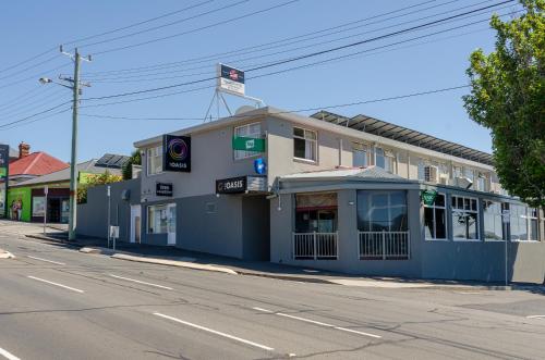 a building on the corner of a street at Marquis Hotel Motel in Hobart