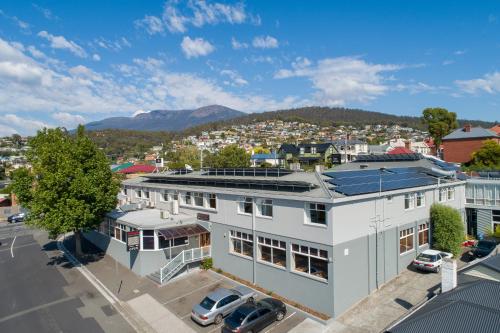 an overhead view of a white building with a parking lot at Marquis Hotel Motel in Hobart