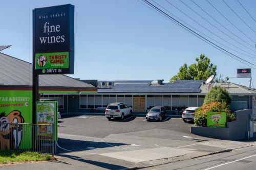 a shopping center with cars parked in a parking lot at Marquis Hotel Motel in Hobart