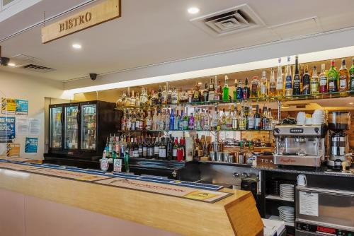 a bar with a lot of bottles of alcohol at Marquis Hotel Motel in Hobart