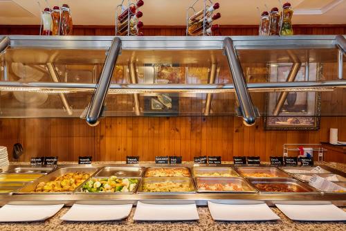a buffet line with many trays of food at Marquis Hotel Motel in Hobart