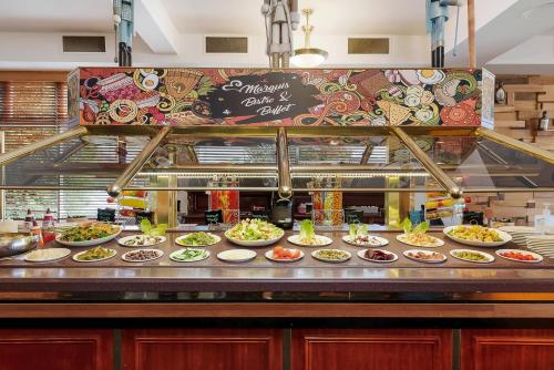 a buffet line with plates of food on display at Marquis Hotel Motel in Hobart